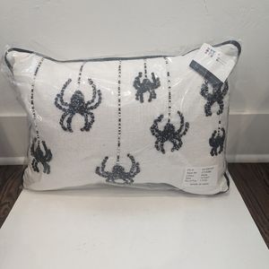 White pillow with black spiders.